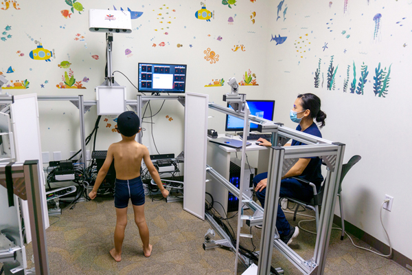 study participant in front of 3D scanning machine